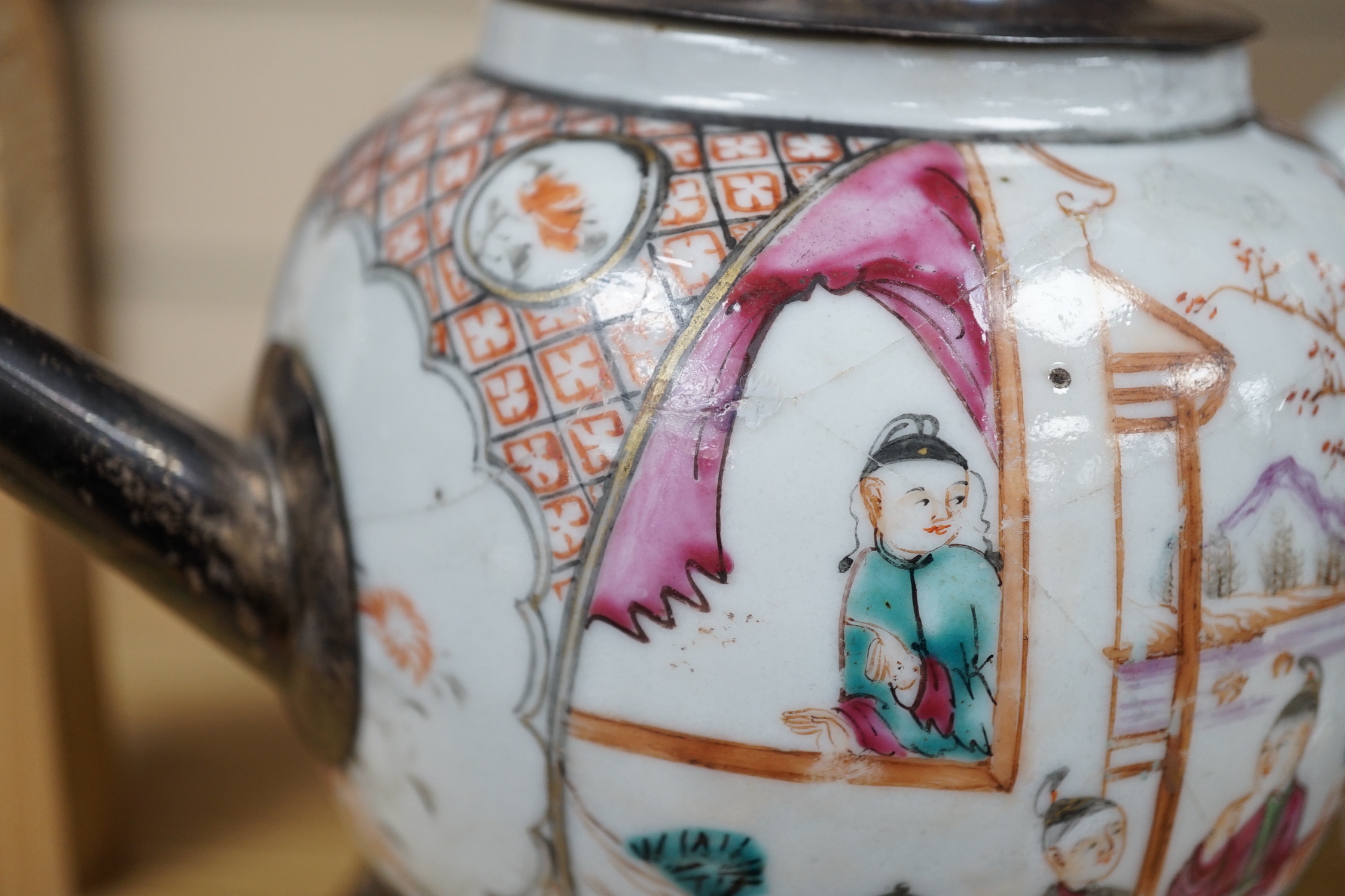 An 18th century Chinese export famille rose teapot with later silver spout and cover, on hardwood stand